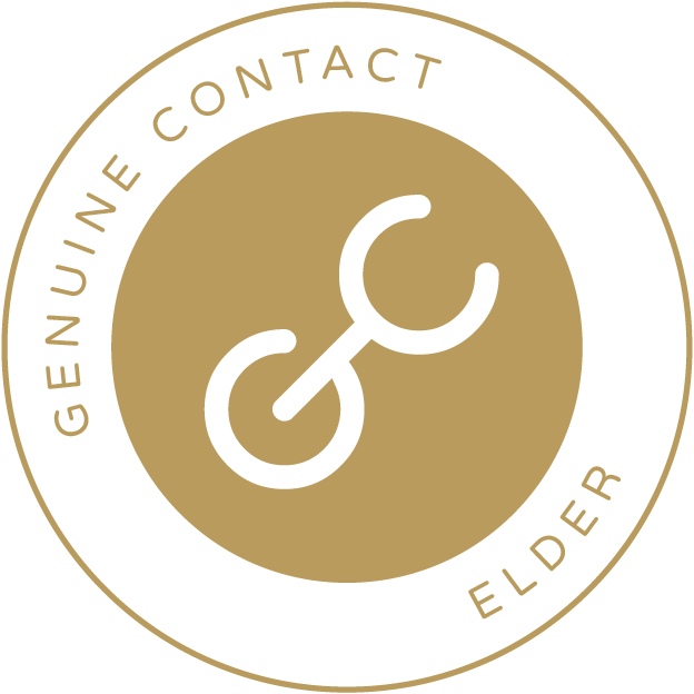 Genuine Contact Elder membership badge. The badge is a circle with an outer ring that has the words "Genuine Contact Elder" in gold text on a white background and an inner circle with the Genuine Contact logo in it. The logo is a stylized letter G and C together on a gold background.