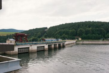 Photo of waterworks at the edge of a river.